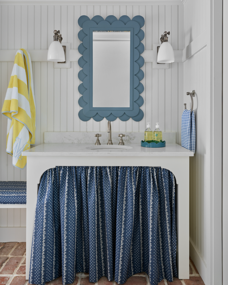pool house bathroom with shiplap walls and blue and yellow accessories