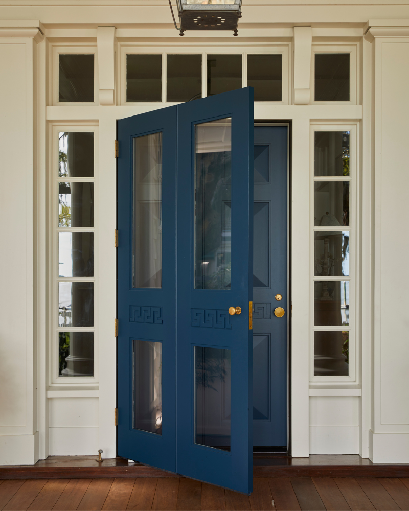 deep blue front door with brass hardware