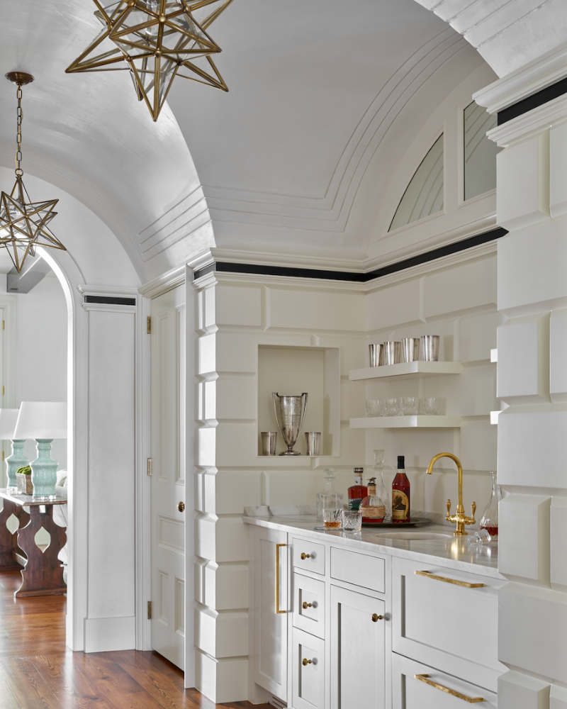 white brick built-in wet bar with star chandeliers at a isle of hope georgia family home