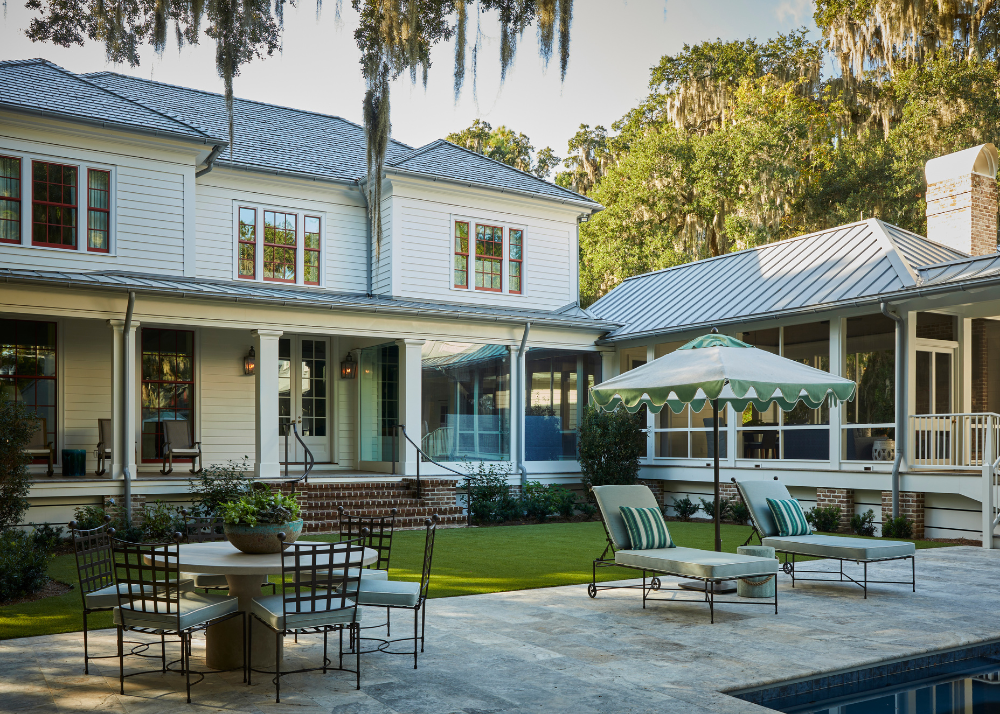 exterior of a traditional southern home with a pool and many lounge areas
