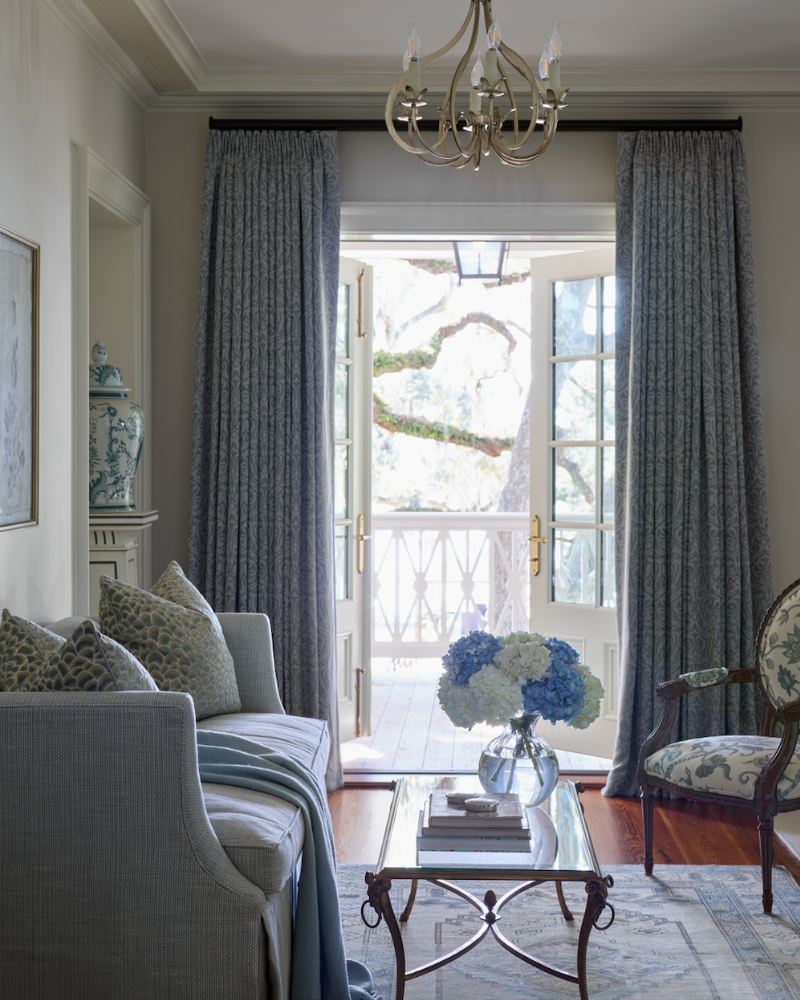 sitting area with a blue sofa in a traditional isle of hope georgia home