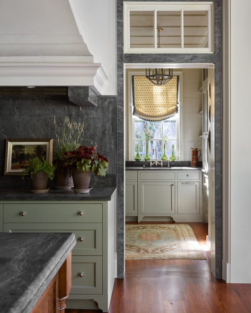 kitchen with green cabinets in a traditional isle of hope georgia home