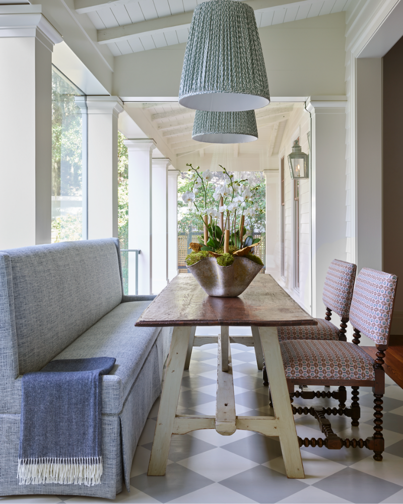dining area with a bench and rustic table in a traditional isle of hope georgia home