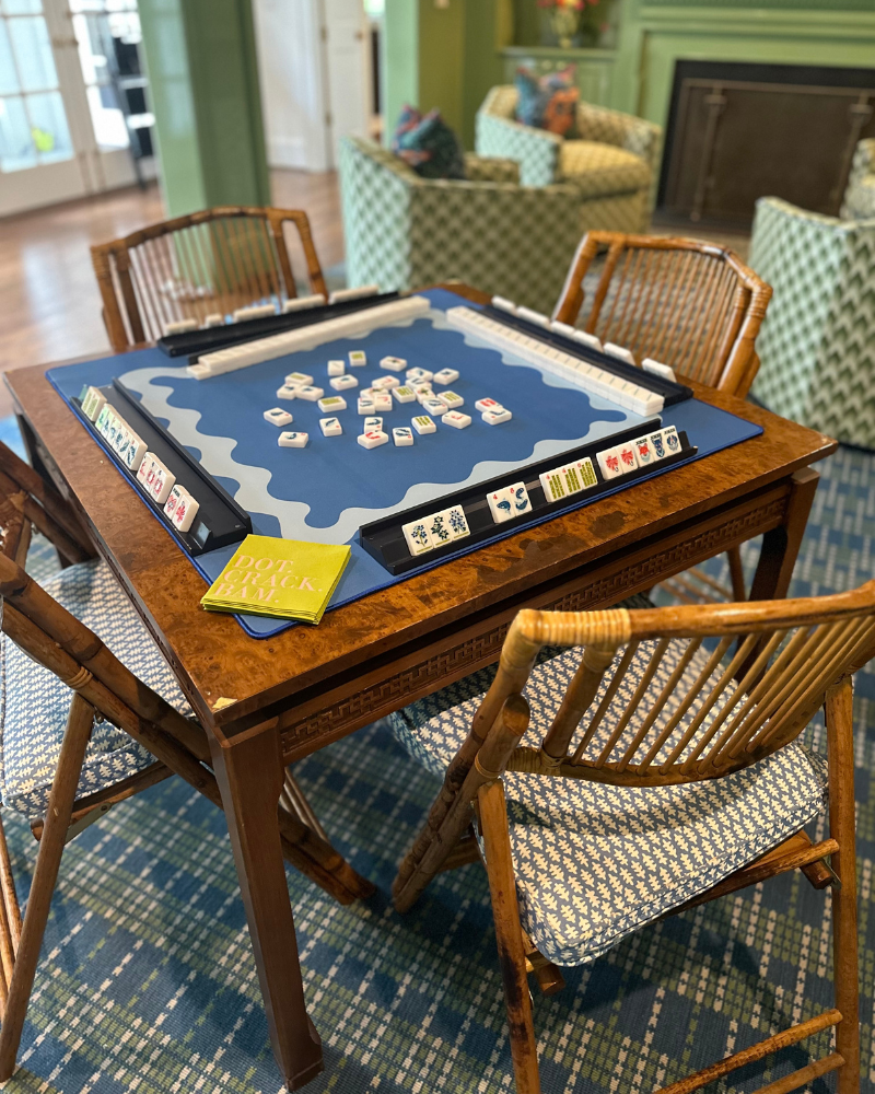 Green room with a game table, bamboo chairs and majong set