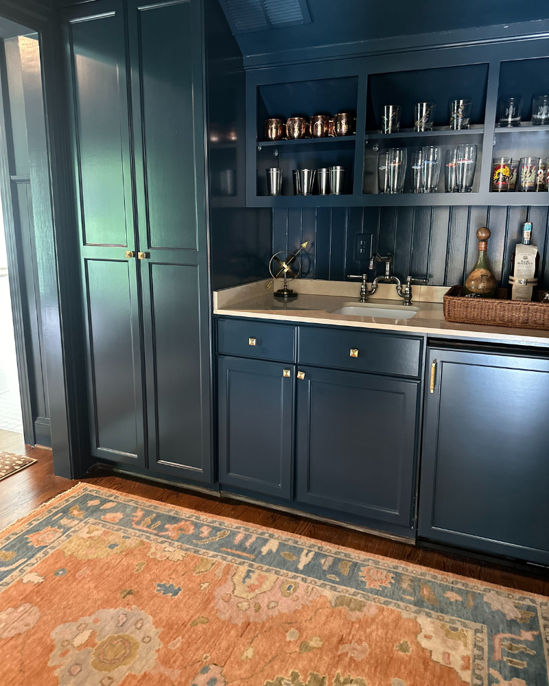 dark blue painted cabinets and bar