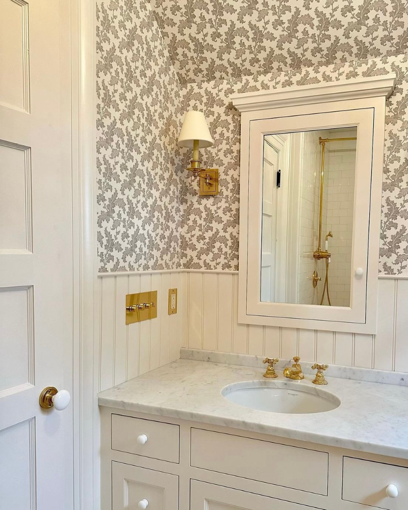 neutral bathroom with botanical wallpaper, bead board and single sink