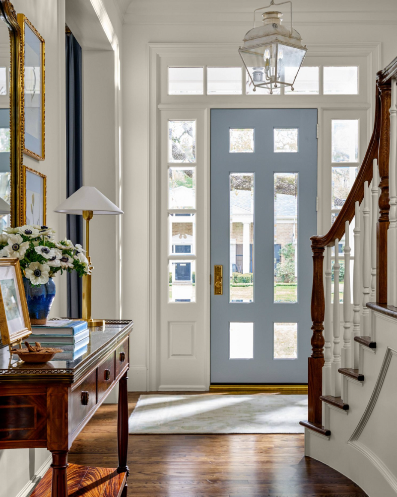 blue front door painted on the inside of a traditional foyer