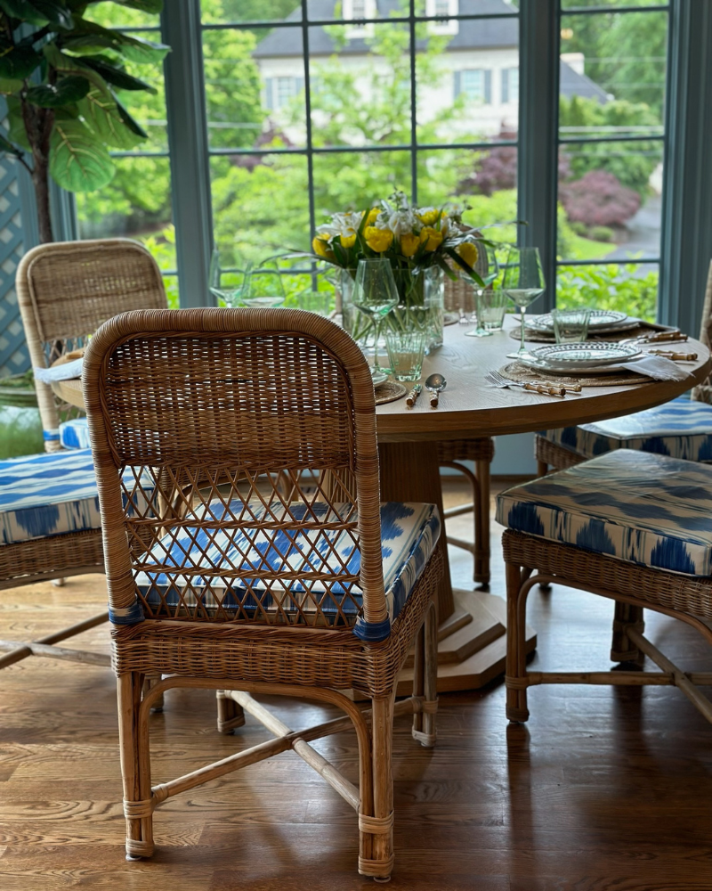 classic raleigh home with rattan dining set and blue cushsions