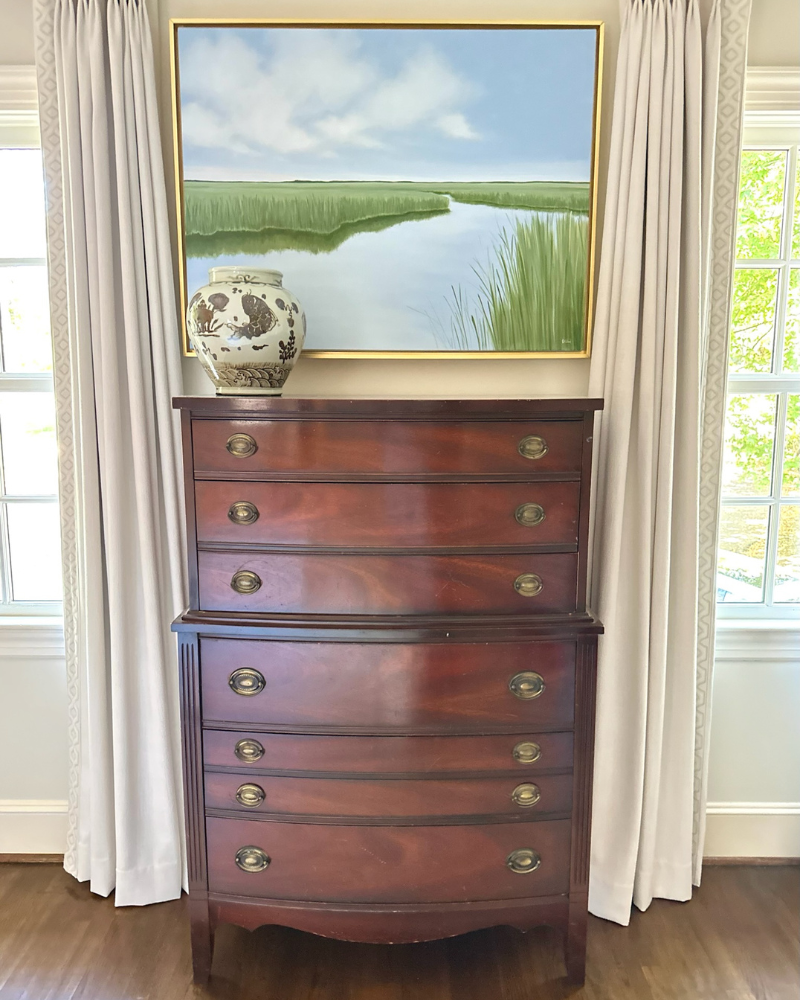 tall bowfront chest in traditional primary bedroom