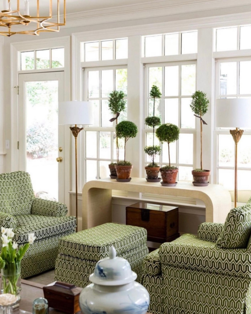 indoor potted topiaries on a waterfall table in a sitting room